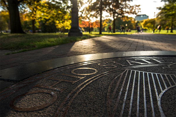 university seal on the Oval sidewalk