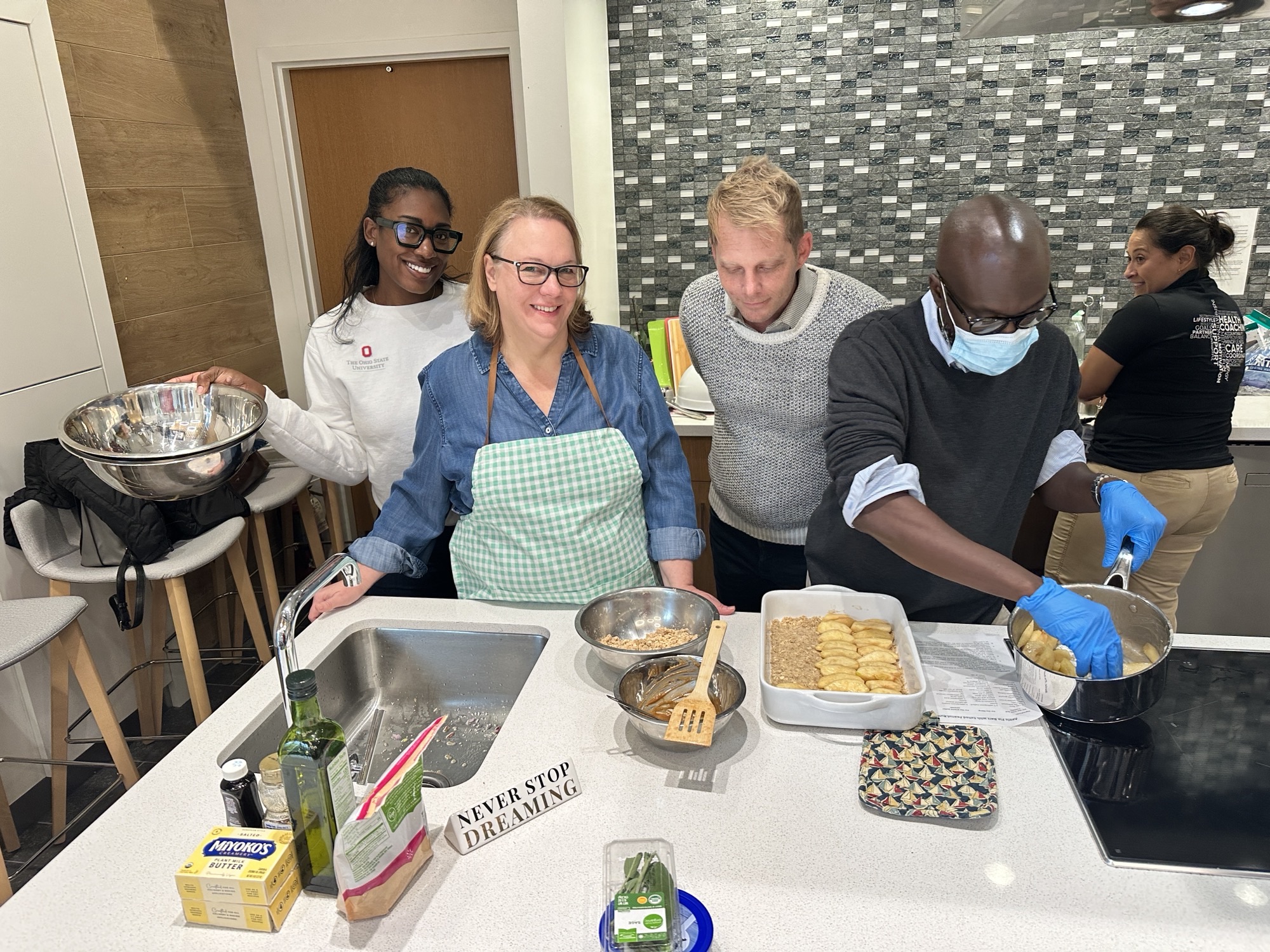 four people preparing food