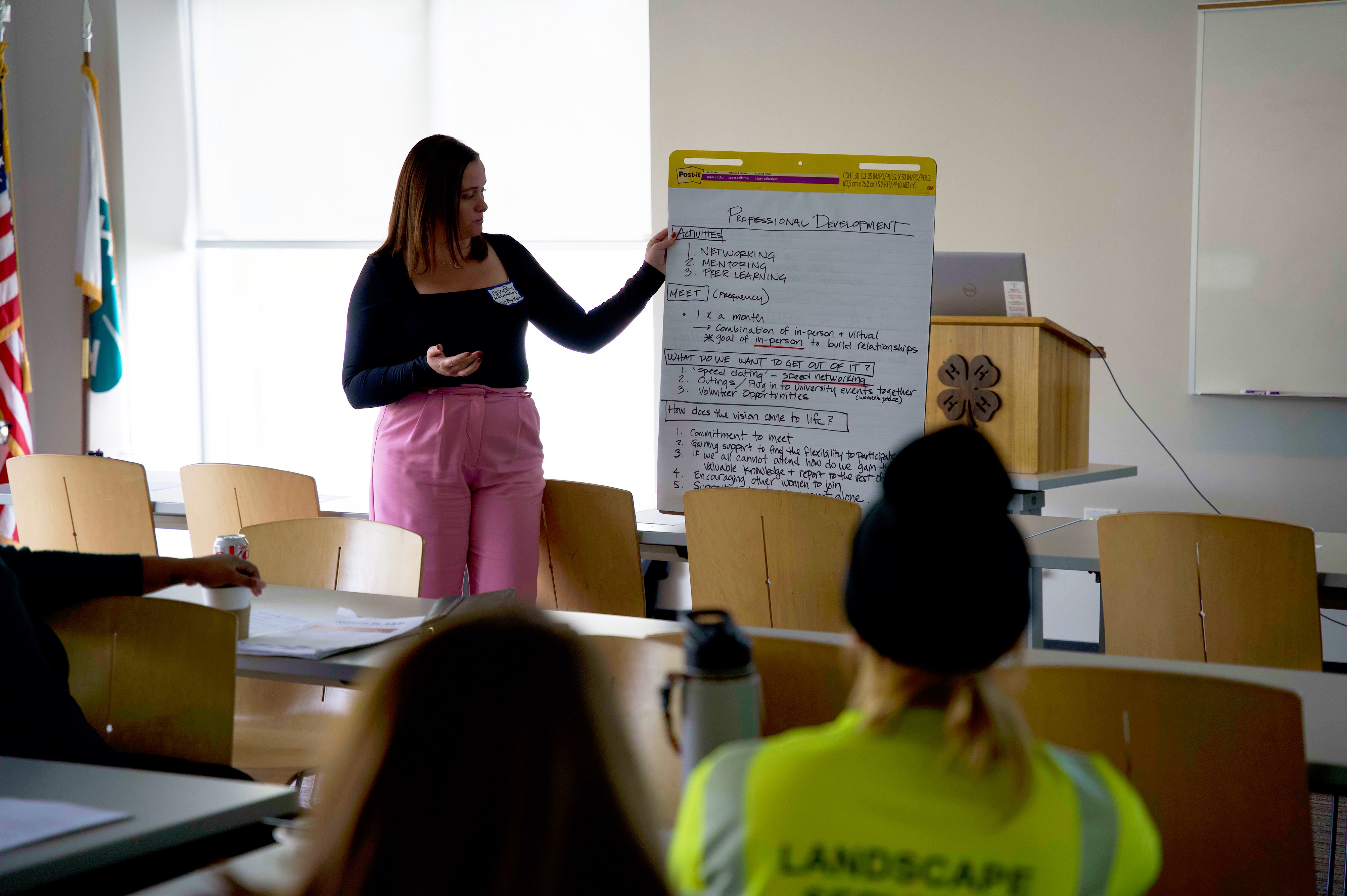 An instructor in front of a whiteboard with professional development tips.