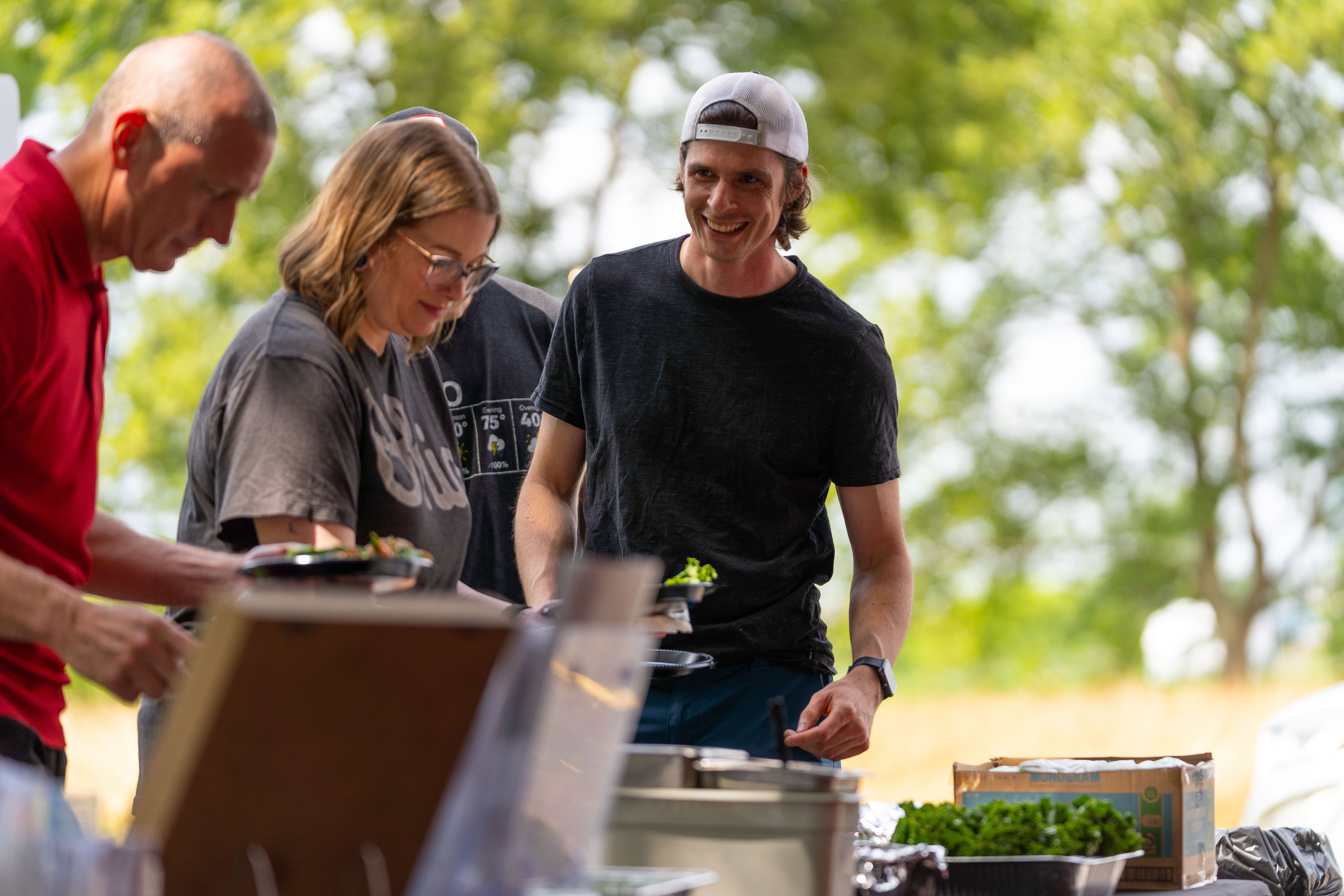 people adding food to plate