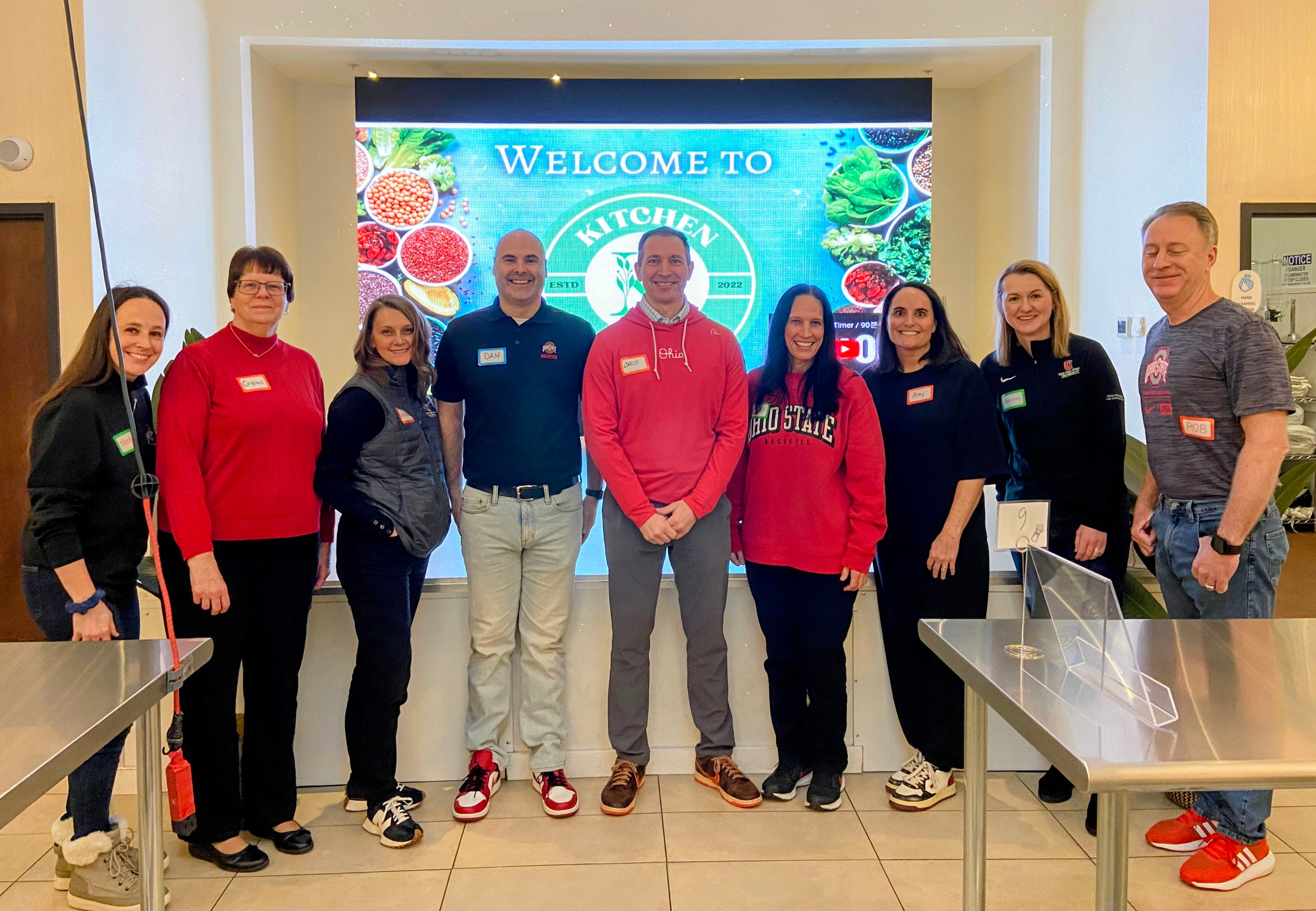 A&amp;P leaders are seen standing, smiling for a photo.