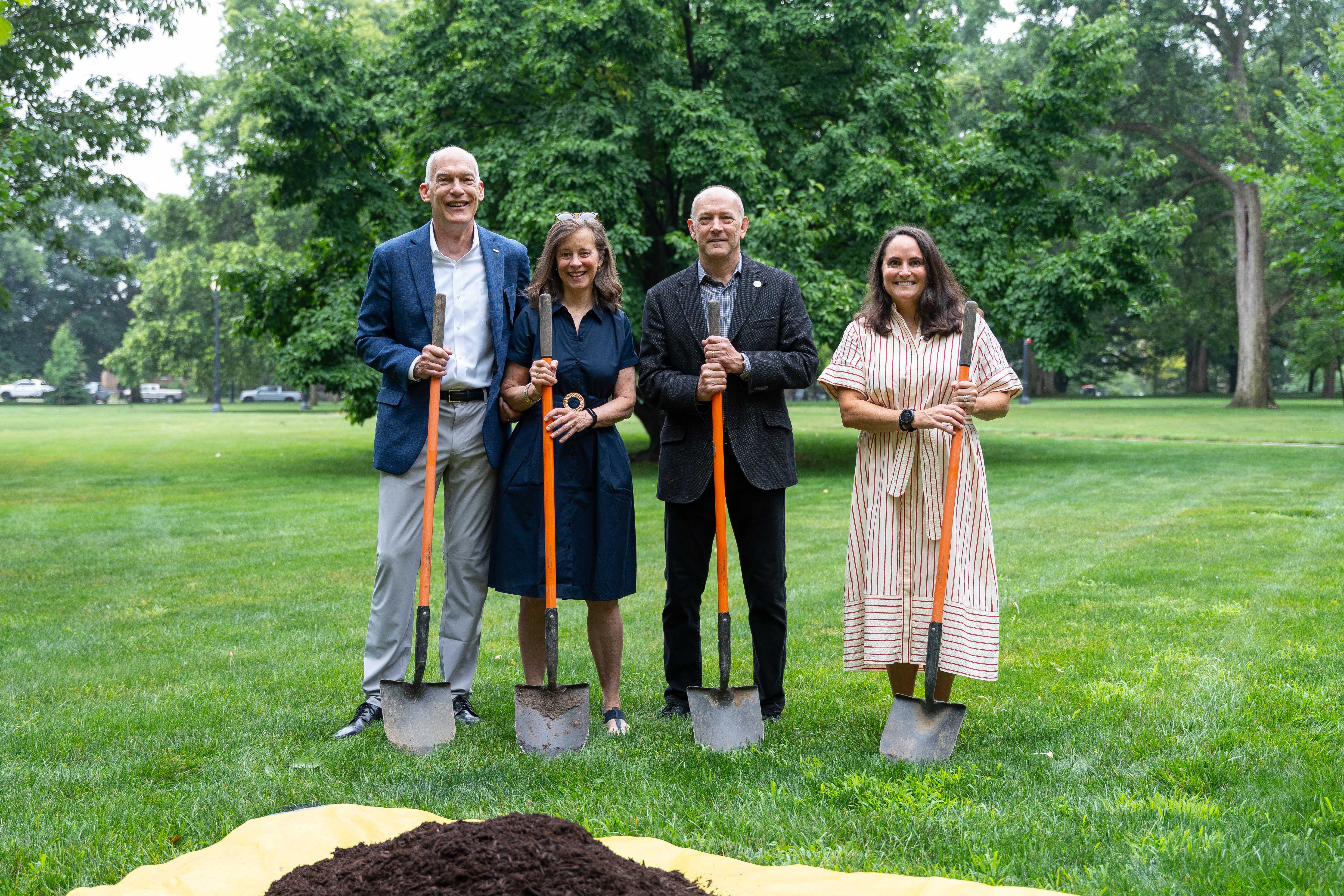 Jay Kasey, his wife, Mark Conselyea and Amy Burgess holding shovels.