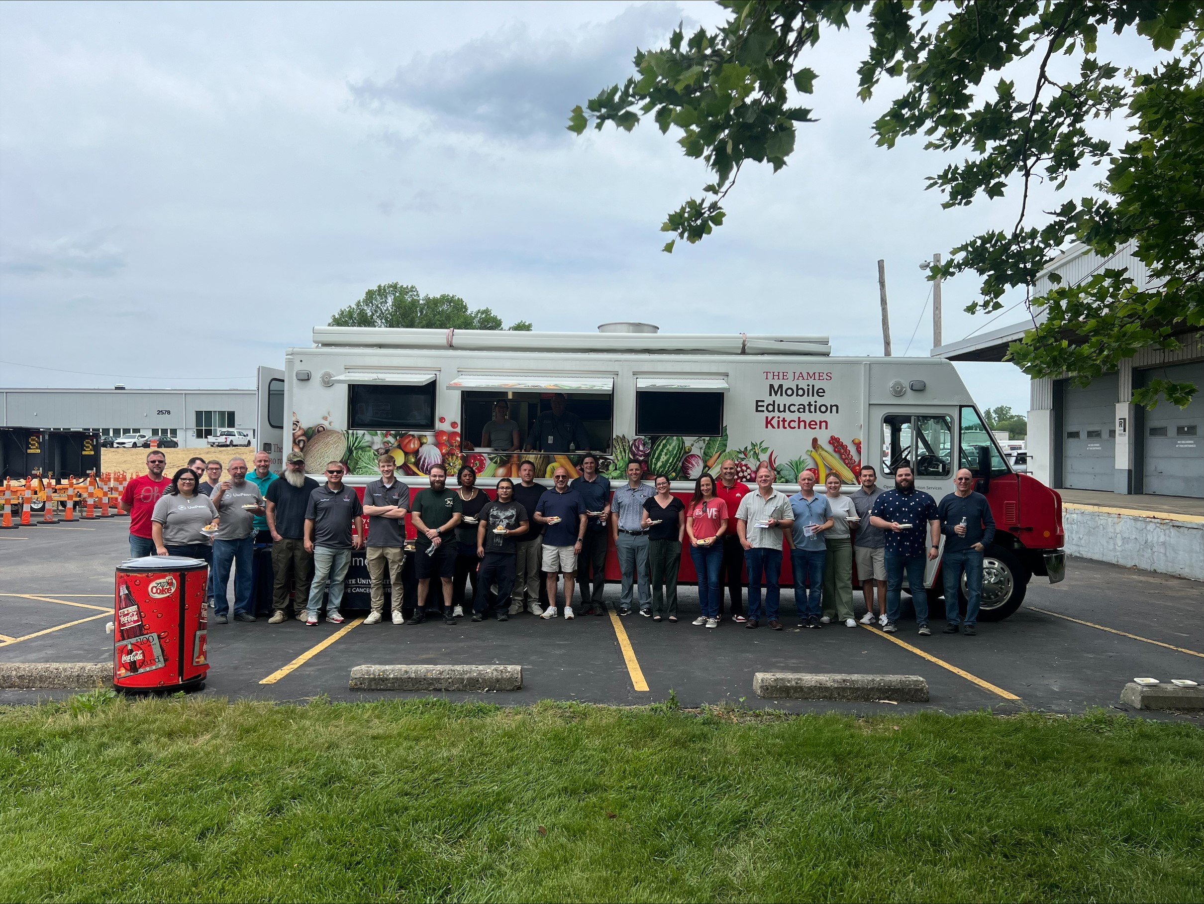 group of people standing in front of truck