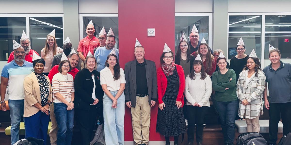 group of people with birthday hats