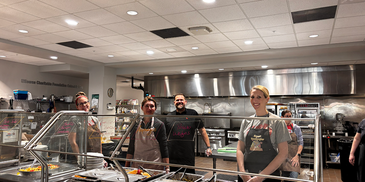 team standing in a kitchen
