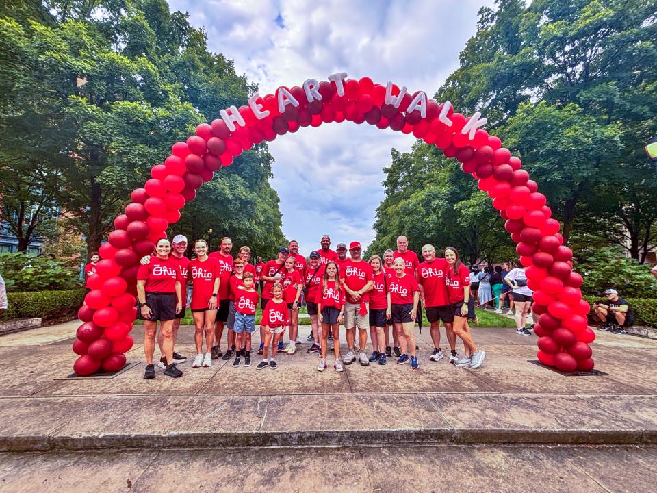 A&amp;P Team Heart and Sole at the Heart Walk standing under a balloon arch made of scarlet balloons