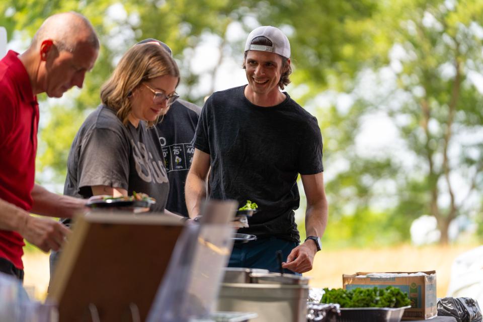 people adding food to plate